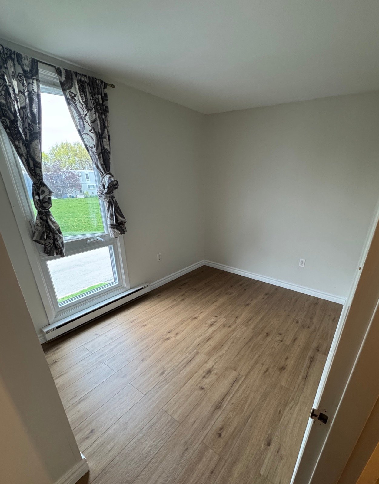 Bedroom after professional interior painting by The Hamilton Painting Company in Hamilton, Ontario — tonal walls and crisp trim for a calmer, more restful space